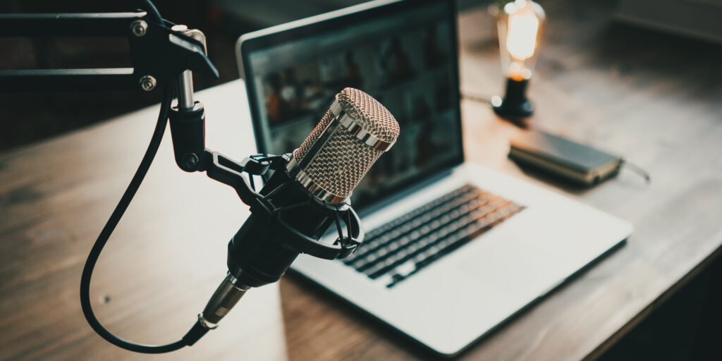 Home studio podcast interior. Microphone, laptop and on air lamp