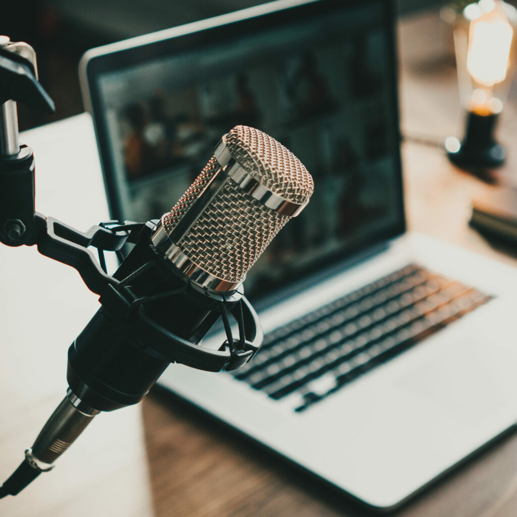 Home studio podcast interior. Microphone, laptop and on air lamp